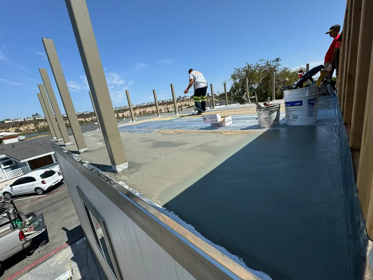 Safety decking installation in progress with waterproofing materials being applied