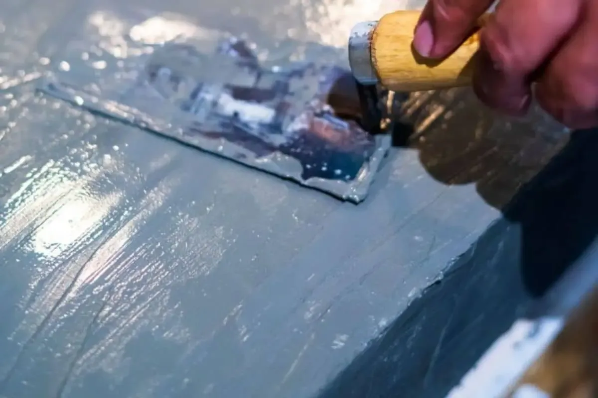 Waterproof coating applied to a concrete surface with a hand trowel