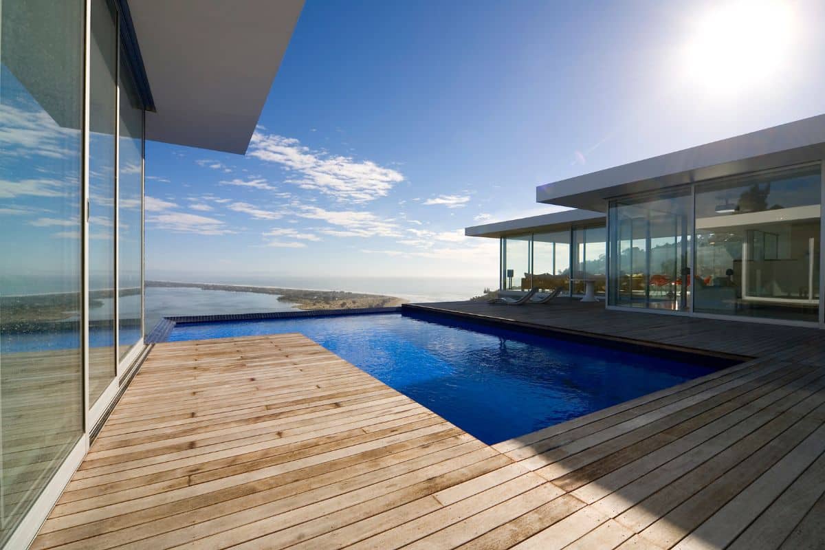 Modern Orange County pool deck with professional waterproof deck coating and ocean view