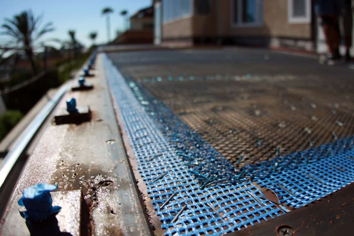 Waterproof deck membrane creates a sealed barrier that protects exterior decks from water damage.