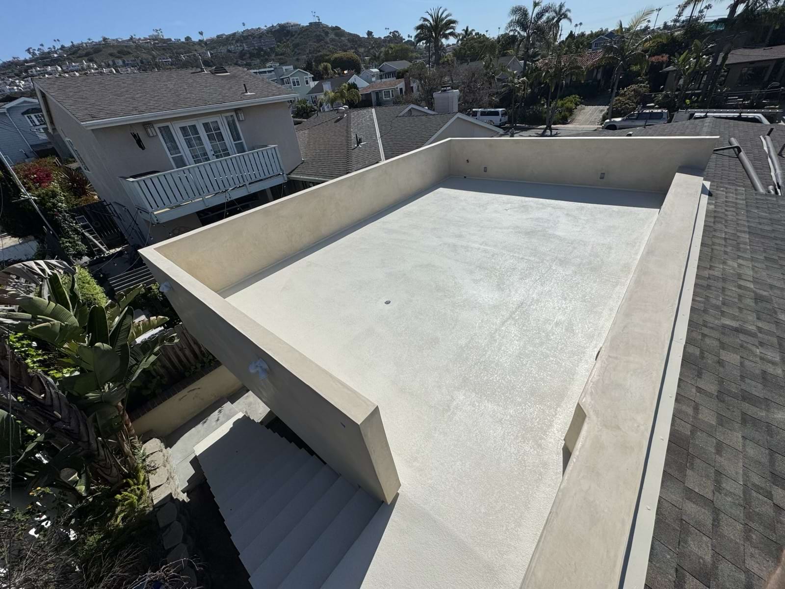 Liquid coatings waterproofing being applied on an elevated roof deck